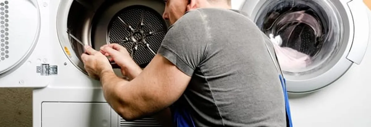 Dryer repair technician fixing a clothes dryer drum in New Orleans, LA